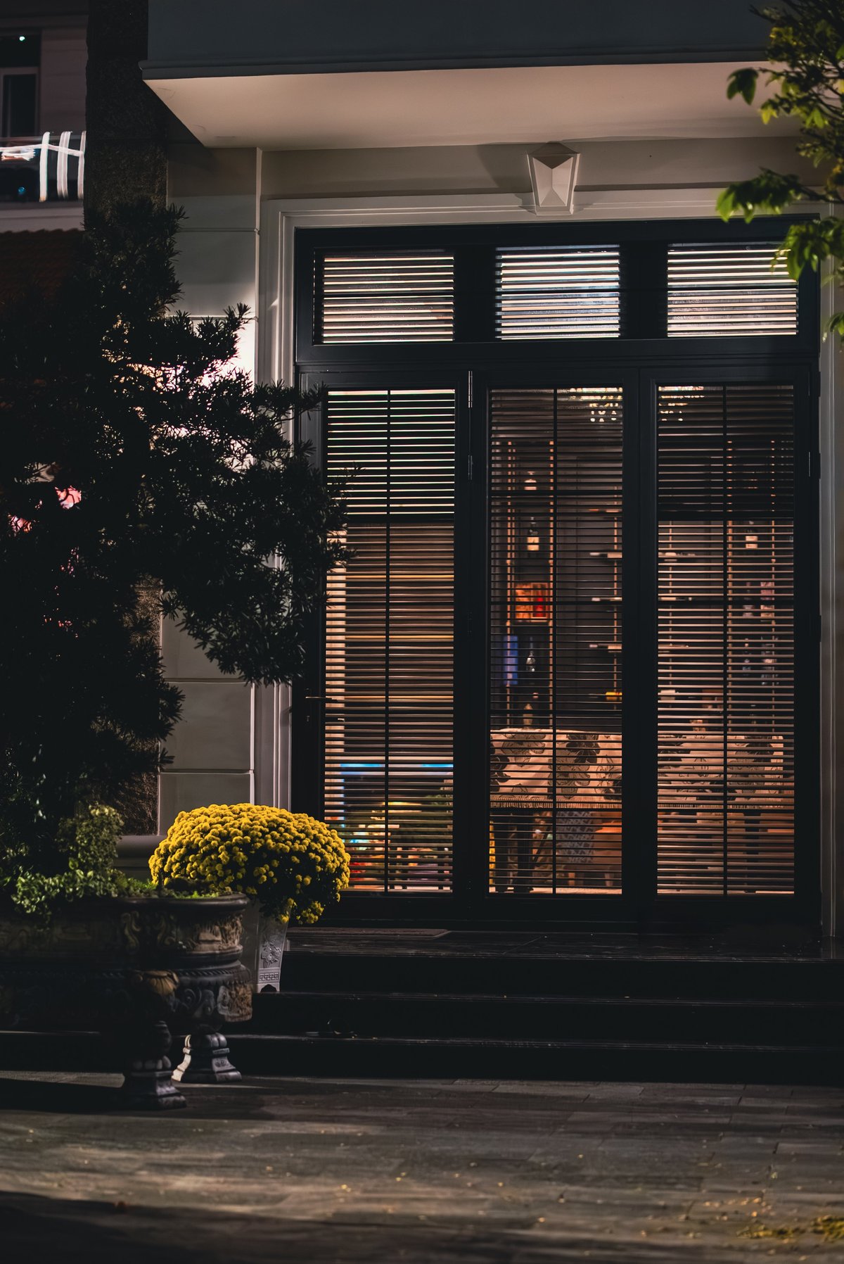 Elegant residential doorway with warm evening lighting and refined architecture